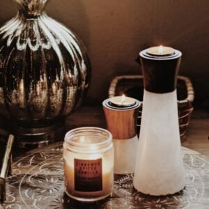 white and brown candle holders beside votive candle